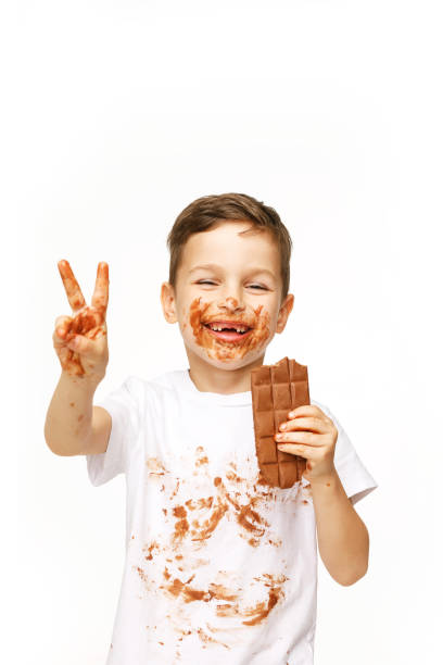 istock little boy with face and hands in chocolate 1137044390