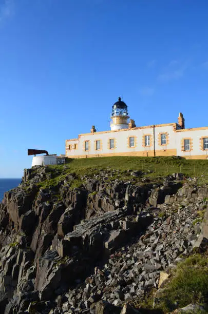 Rugged rocky cliffs at Neist Point Lighthouse in Scotland.