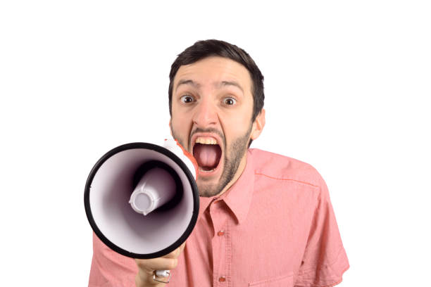 istock Young man screaming on a megaphone. 1137045419