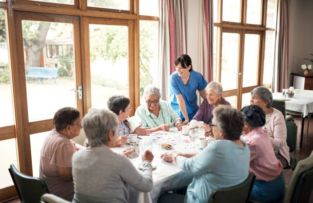Who said playtime was just for kids? Shot of a group of senior women playing cards together at a retirement home afternoon tea photos stock pictures, royalty-free photos & images