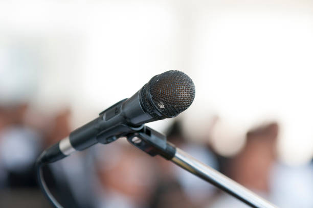 istock Microphone In the seminar room, blurred people background. 1137045844