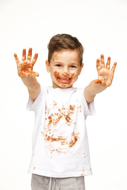 istock little boy with face and hands in chocolate 1137045852