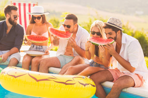 istock Friends eating watermelon 1137045900