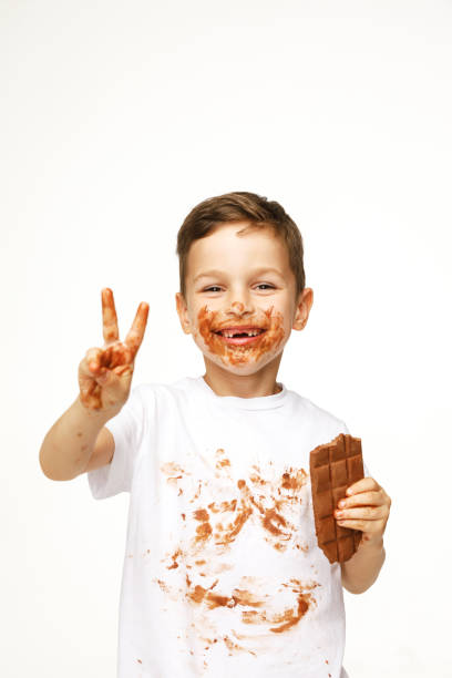 istock little boy with face and hands in chocolate 1137045905