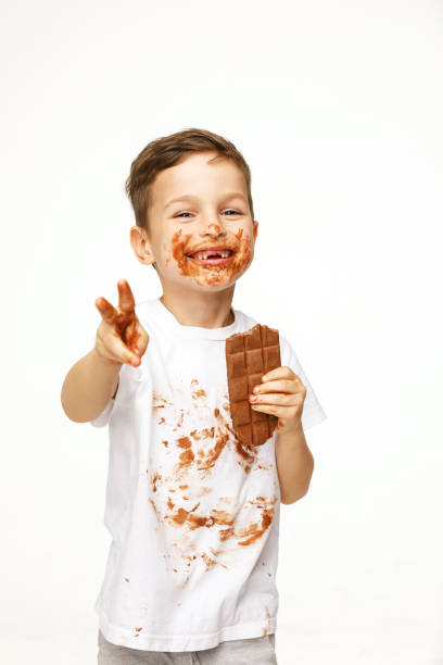 istock little boy with face and hands in chocolate 1137047040