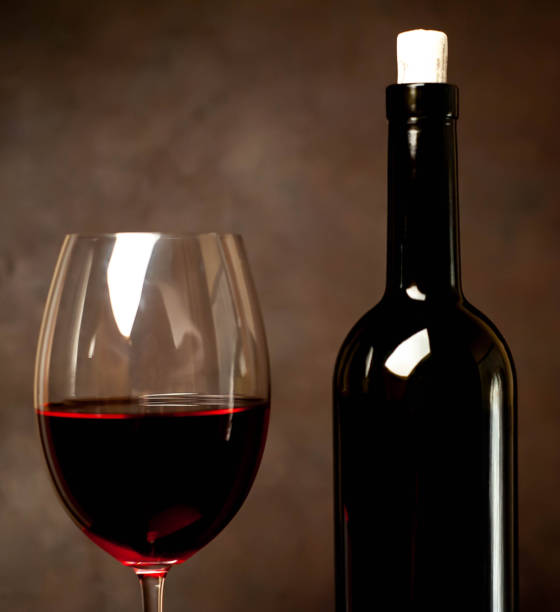 istock Red wine glasses and a bottle with wine on a stone background. View from above 1137047134
