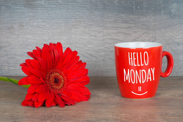 istock hello monday, motivational card with red gerbera and coffee cup 1137047199