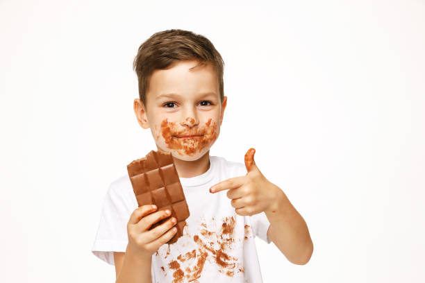 istock little boy with face and hands in chocolate 1137047516