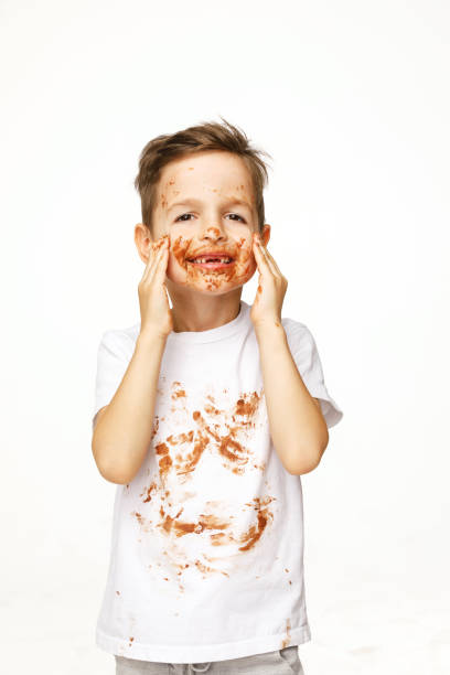 istock little boy with face and hands in chocolate 1137048201