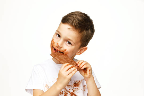 istock little messy boy is eating chocolate studio shot 1137048358
