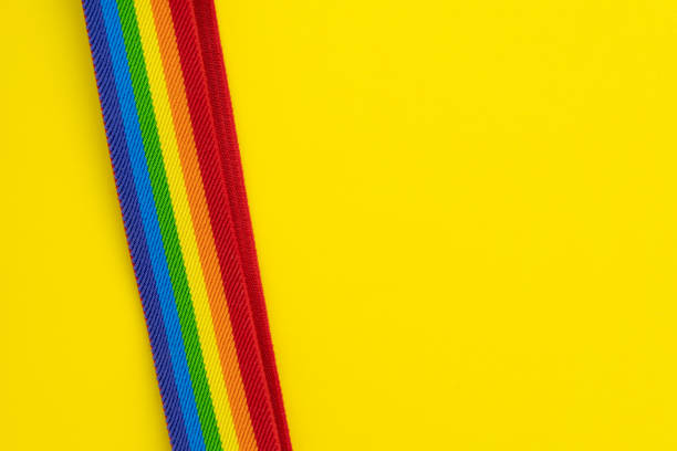istock LGBT rainbow headband on solid yellow background with copy space using as celebrate of homosexual, lesbian, gay and transgender concept 1137048505