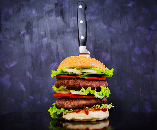 istock Delicious handmade burger on dark background. Close view 1137048538
