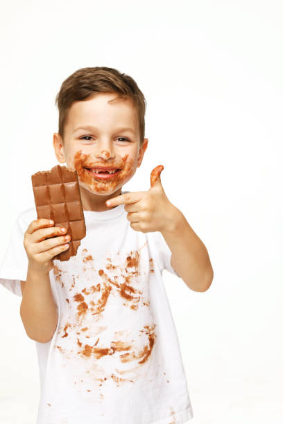 istock little boy with face and hands in chocolate 1137048583