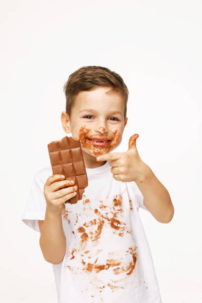 istock little boy with face and hands in chocolate 1137048745