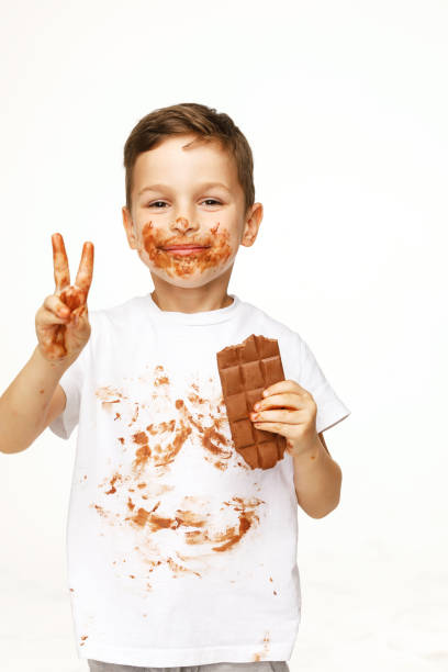 istock little boy with face and hands in chocolate 1137049810