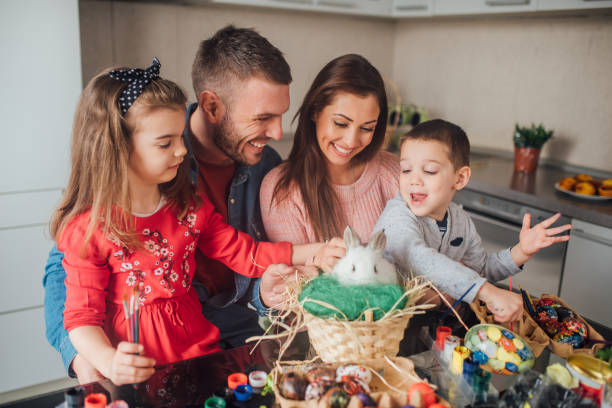 istock Happy family with pet rabbit 1137049821