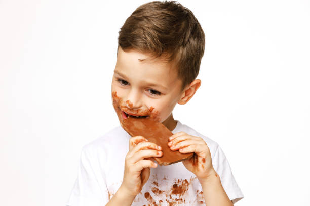 istock little messy boy is eating chocolate studio shot 1137050010