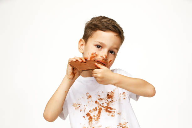 istock little messy boy is eating chocolate studio shot 1137050218