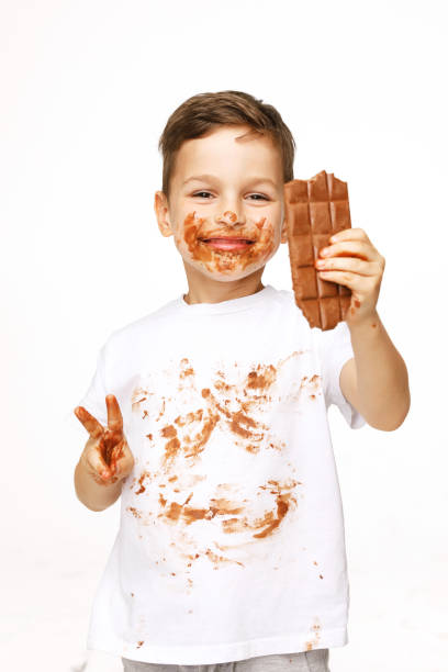 istock little boy with face and hands in chocolate 1137050279