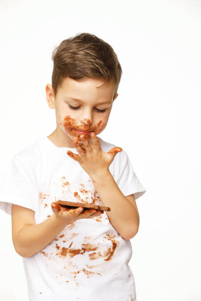 istock little boy with face and hands in chocolate 1137050498