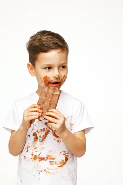 istock little messy boy is eating chocolate studio shot 1137051179