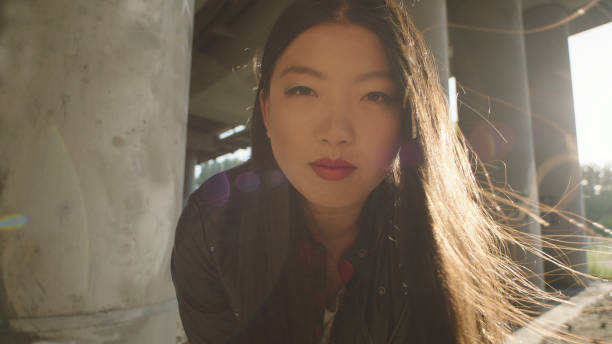 istock Asian woman looking at camera under bridge. 1137051384