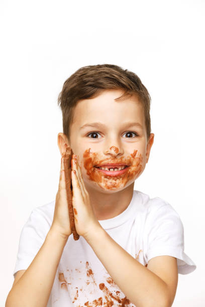 istock little boy with face and hands in chocolate 1137051725