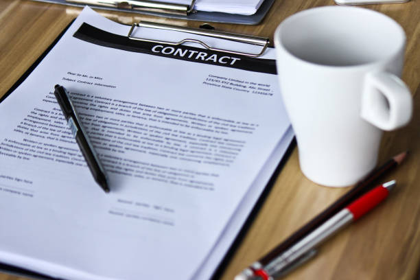 istock The contract document and a cup of coffee on the table 1137051740
