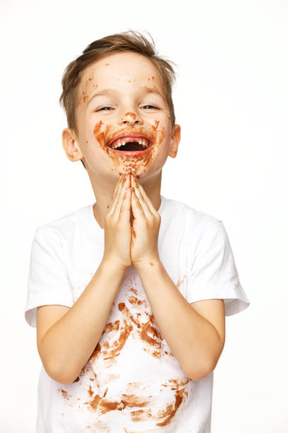 istock little boy with face and hands in chocolate 1137051764