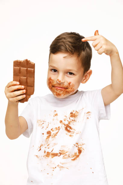 istock little boy with face and hands in chocolate 1137052944