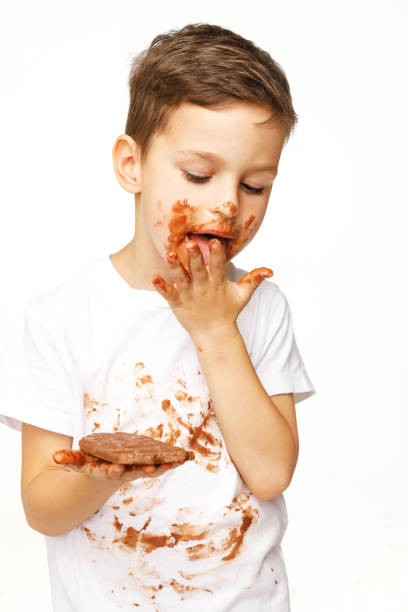 istock little boy with face and hands in chocolate 1137053007