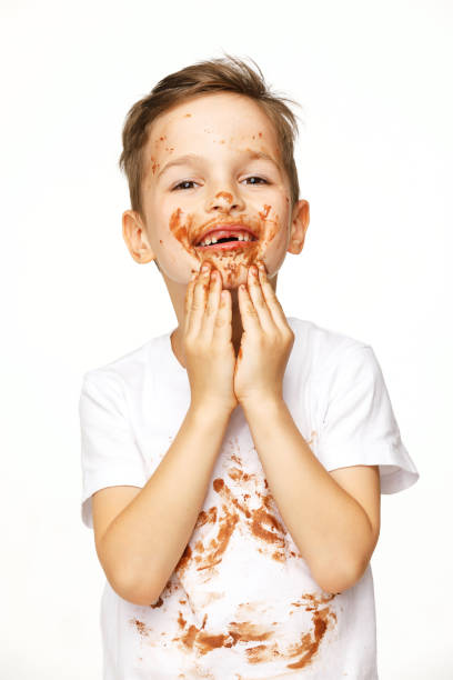 istock little boy with face and hands in chocolate 1137053050