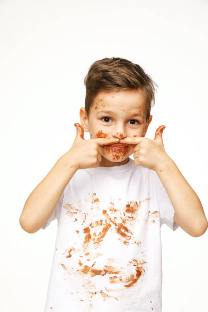 istock little boy with face and hands in chocolate 1137053124
