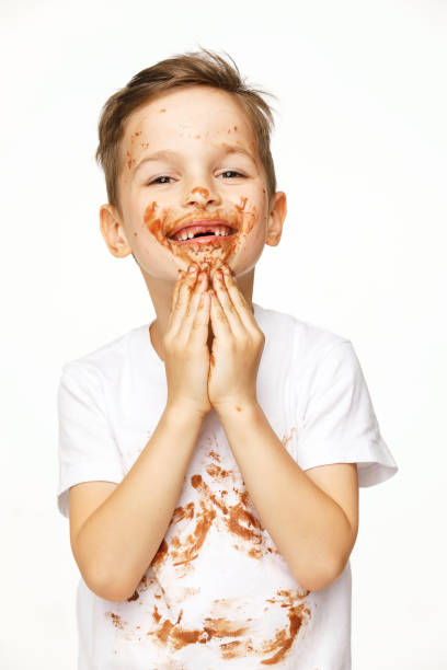 istock little boy with face and hands in chocolate 1137053210