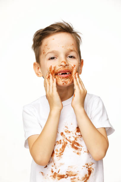 istock little boy with face and hands in chocolate 1137053289
