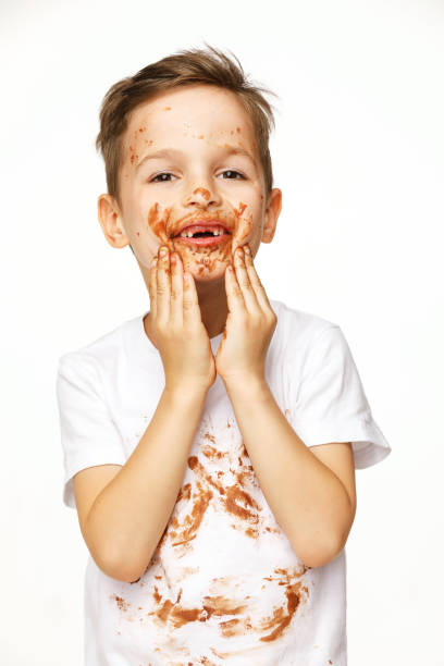 istock little boy with face and hands in chocolate 1137053948