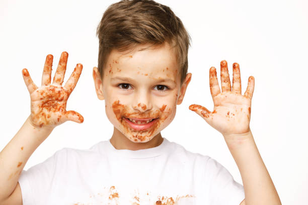 istock little boy with face and hands in chocolate 1137054068