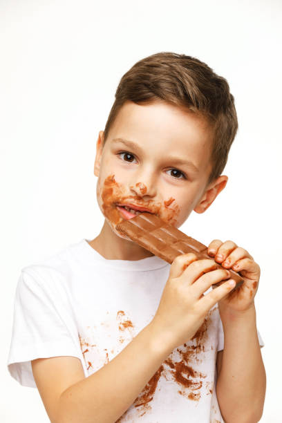 istock little messy boy is eating chocolate studio shot 1137054277
