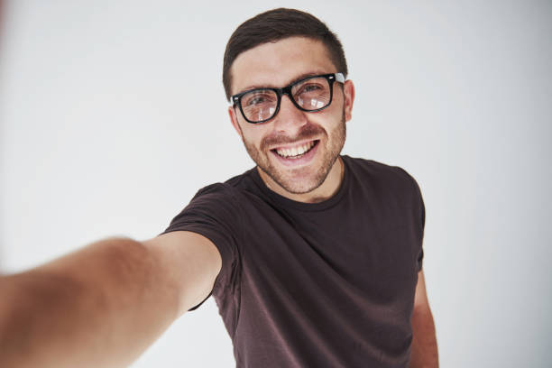istock Young hipster guy wearing glasses laughing happily isolated on white background 1137054304