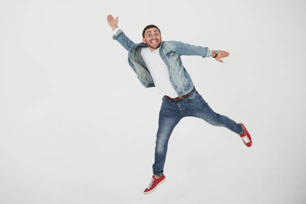 istock Image of cheerful young man casual dressed jumping over white background make different gesture 1137054661