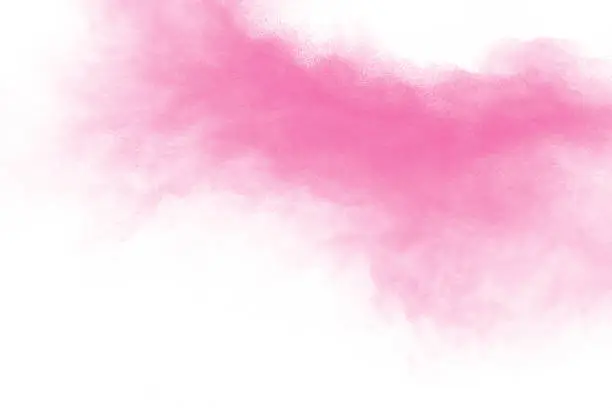 Photo of Bizarre forms of pink powder splatter on white background.