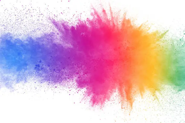 Photo of Colorful powder explosion on white background. Abstract pastel color dust particles splash.