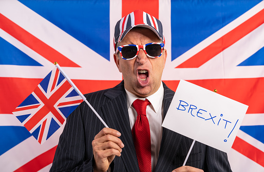 British male businessman with Brexit banner and UK flag