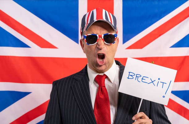 British male businessman Brexit banner British male businessman with Brexit banner and UK flag betting agents uk stock pictures, royalty-free photos & images