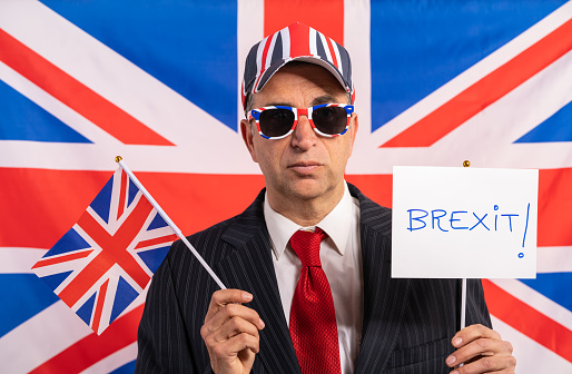 British male businessman with Brexit banner and UK flag