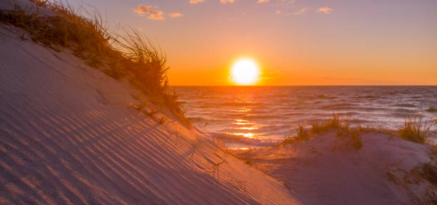 istock Dreamlike View of Sunset Over Sand Dunes on the Shore 1137056921