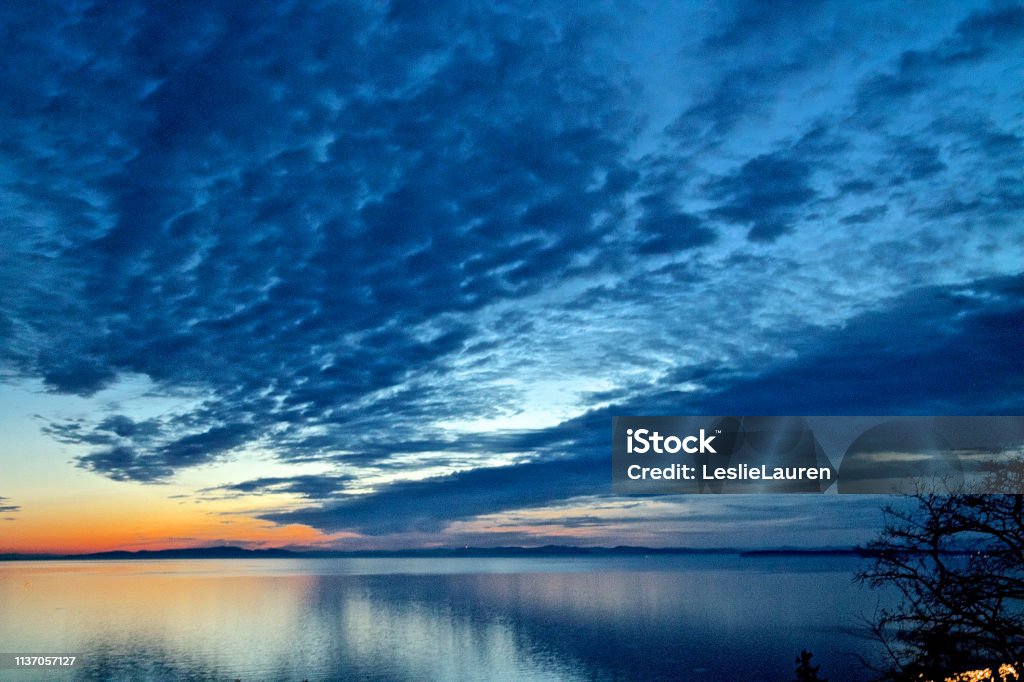 Abstract Cloud Typology Abstract vibrant color clouds with reflection of sunset Quality Stock Photo