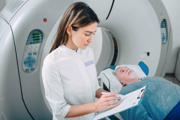 istock doctor write into medical chart after CT Scan 1137058824