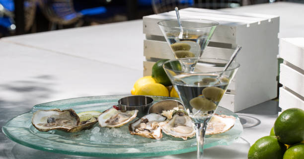 Fresh Oysters Served On Ice Accompanied By A Pair Of Dry Olive Martinis