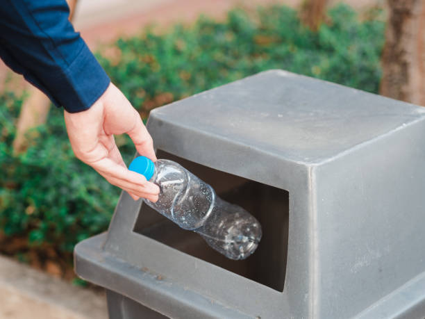 istock Closeup of man hand throwing empty plastic water bottle in a bin. 1137063903